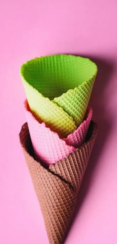 Colorful ice cream cones on pink background.