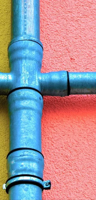 Colorful pipes on pink and yellow wall, vibrant mobile wallpaper.