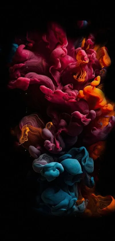 Colorful ink swirl with vibrant pink, orange, and blue splashes on black background.