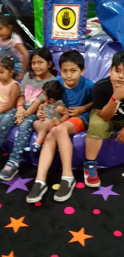 Kids enjoying a colorful play area with star-patterned carpet.