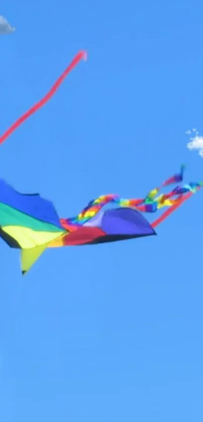 Vibrant kite soaring in a blue sky with fluffy clouds.