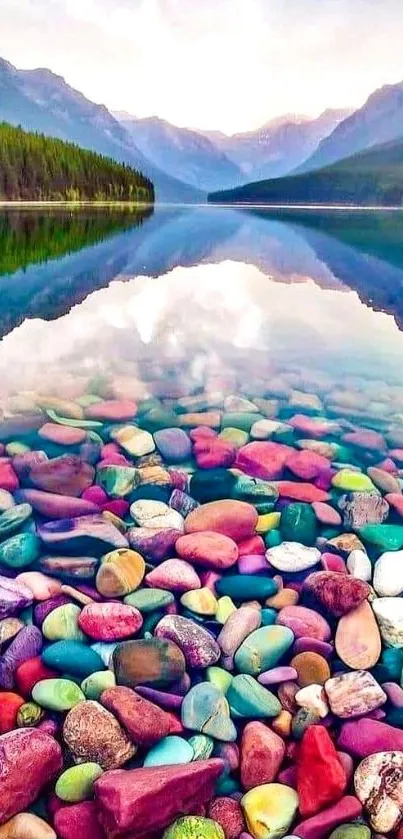 Colorful pebbles under a tranquil lake with mountain reflections.