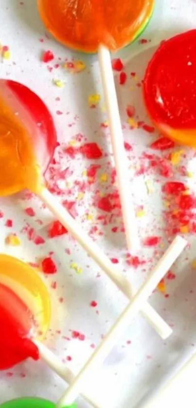 Colorful lollipops on a white table background.