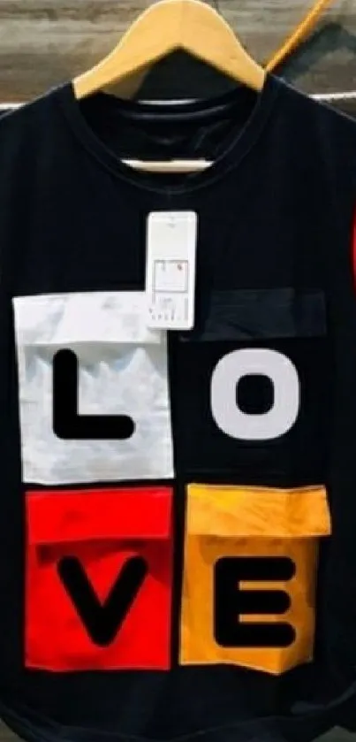 Colorful t-shirt with LOVE design hanging on display.