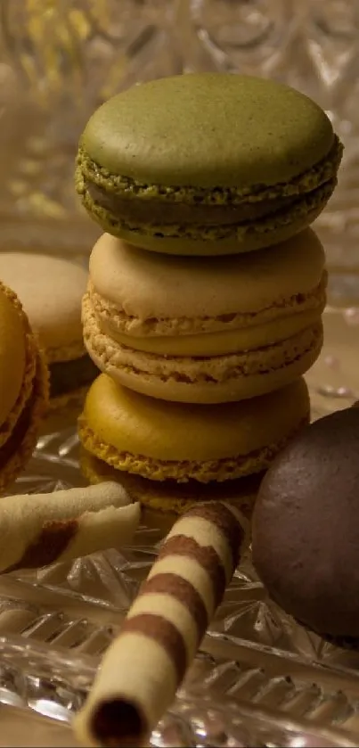 Assorted colorful macarons on a glass plate with decorative elements.