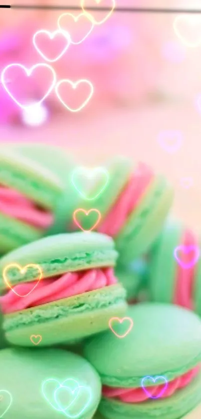 Pastel green macarons with pink filling and heart overlays.