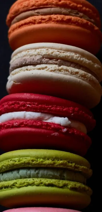 A stack of vibrant colorful macarons on a dark background, perfect for phone wallpaper.