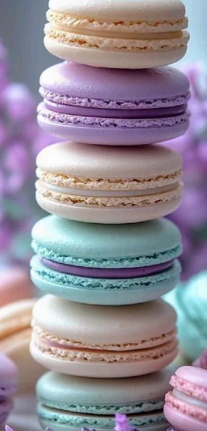 Stack of pastel macarons with floral background.