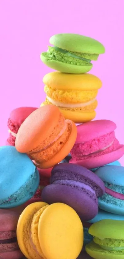 Colorful macaron stack on a bright pink background.