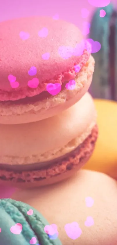 Colorful macarons stacked on a pink background wallpaper.