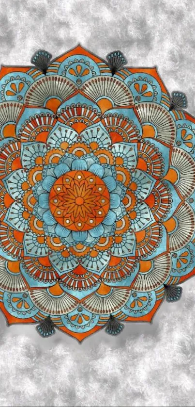 Colorful mandala wallpaper with orange and blue patterns on a textured background.