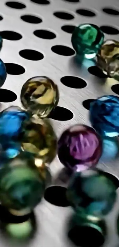 Vibrant marbles on a perforated metal background.