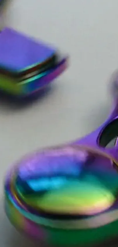 Vibrant iridescent metal spinner with purple, blue, and green hues.