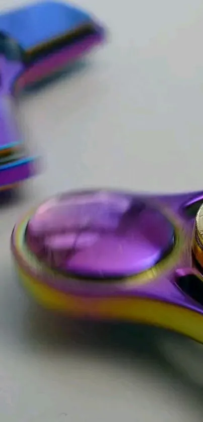 Close-up of a vibrant metallic fidget spinner with purple and yellow hues.