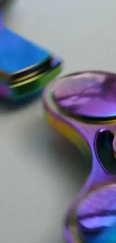 Close-up of a colorful metallic fidget spinner with vibrant hues.