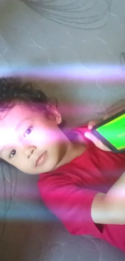 Child holding phone with colorful light effects.