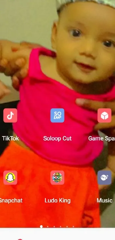 Vibrant child wallpaper with app icons and bright pink shirt.