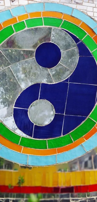 Vibrant mosaic yin yang design with blue and green accents.