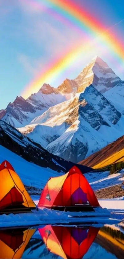 Colorful tents under a rainbow near snow-covered mountains.