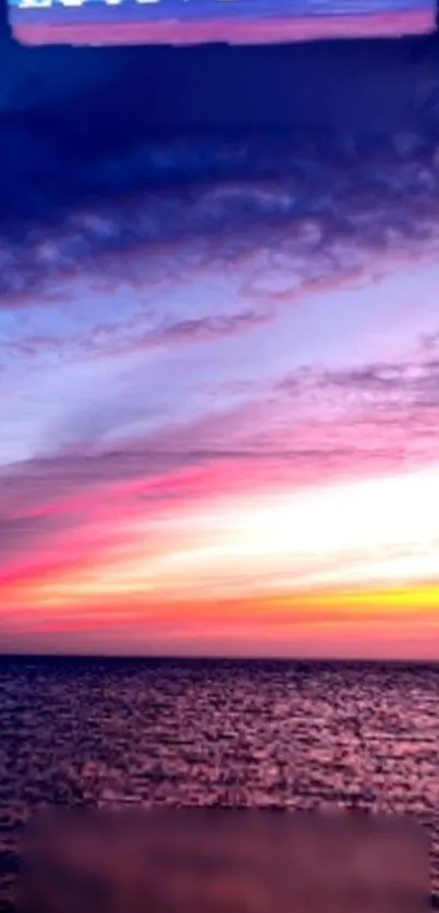 Vibrant ocean sunset with colorful sky over water.