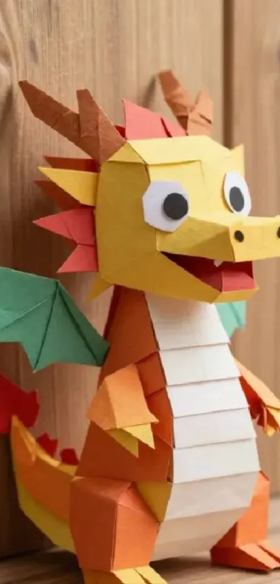 Vibrant origami dragon with wings on wood.