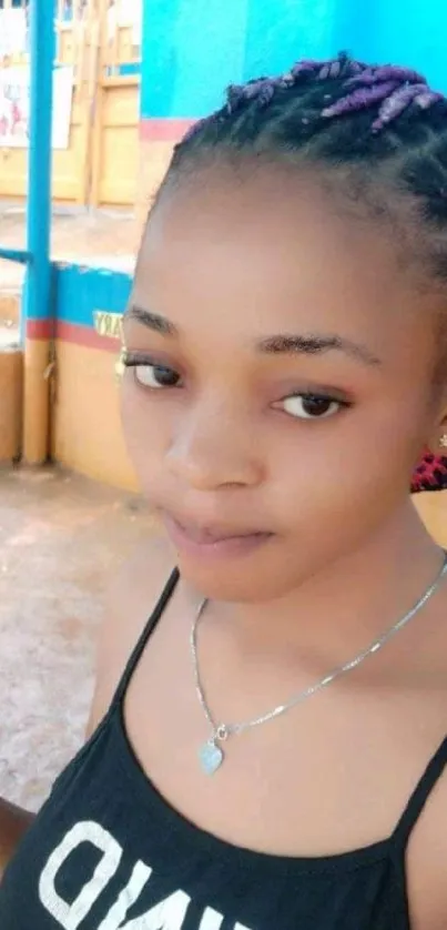 Colorful portrait of a young woman with braided hair.