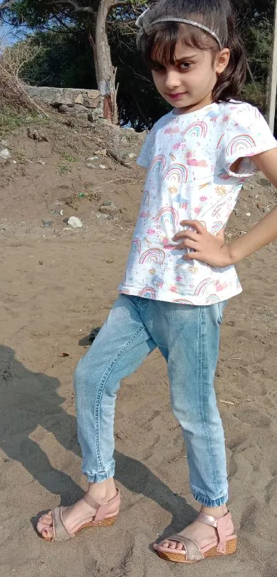 Girl in colorful outfit on sandy outdoor path.