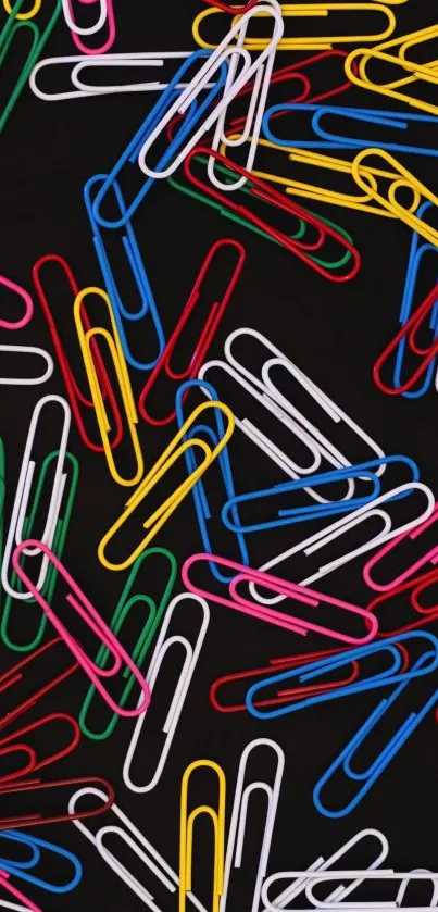 Colorful paperclips scattered on a black background, vibrant mobile wallpaper.