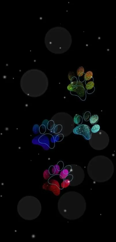 Vibrant paw prints on a black, starry background wallpaper.