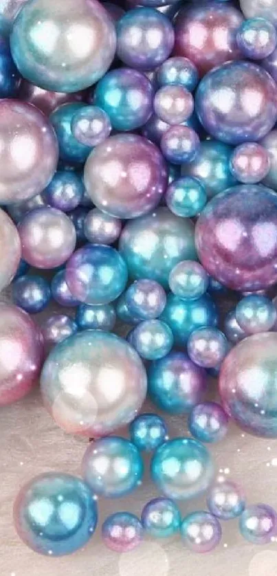 Colorful iridescent pearl beads wallpaper in blue and pink hues.