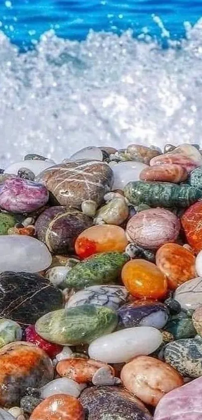 Colorful pebbles with blue ocean waves in background.