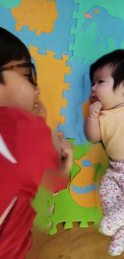 Children playing on colorful foam mats, smiling and interacting.