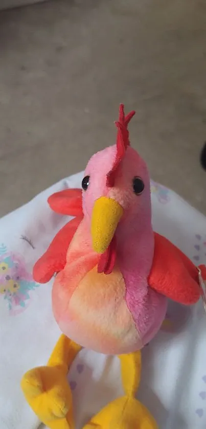 Colorful plush bird toy on soft background.