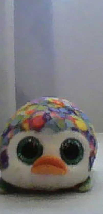 Colorful plush toy with big eyes and vibrant pattern.