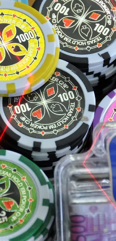 Stacks of vibrant poker chips with euro bills on a wooden surface.
