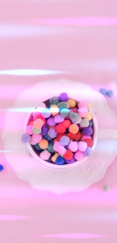 Vibrant pom-poms in a cup on a pink background.