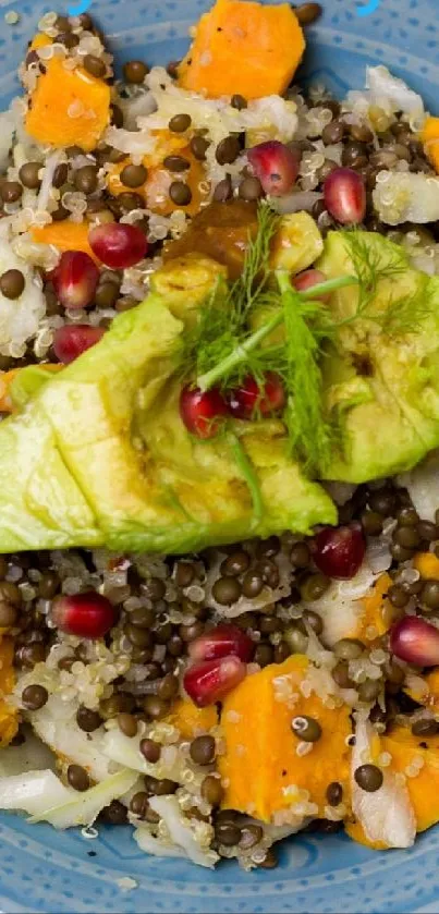 Vibrant salad bowl with quinoa, avocado, and pomegranate seeds.