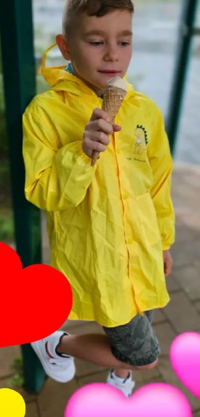 Youth in yellow raincoat enjoying ice cream.