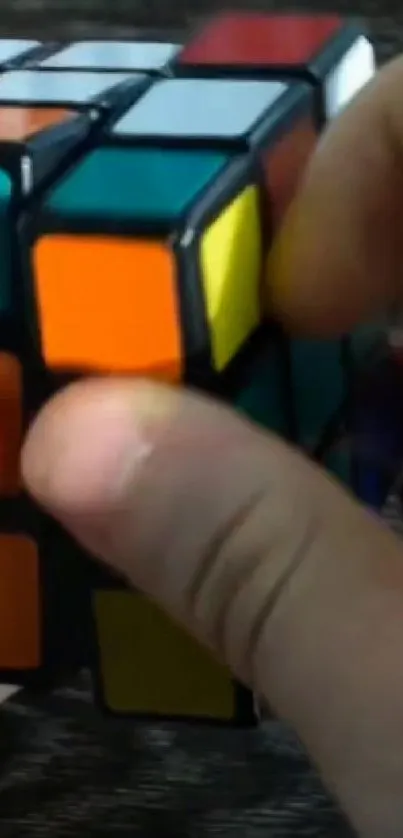 Close-up of a colorful Rubik's Cube puzzle with vivid orange blocks.