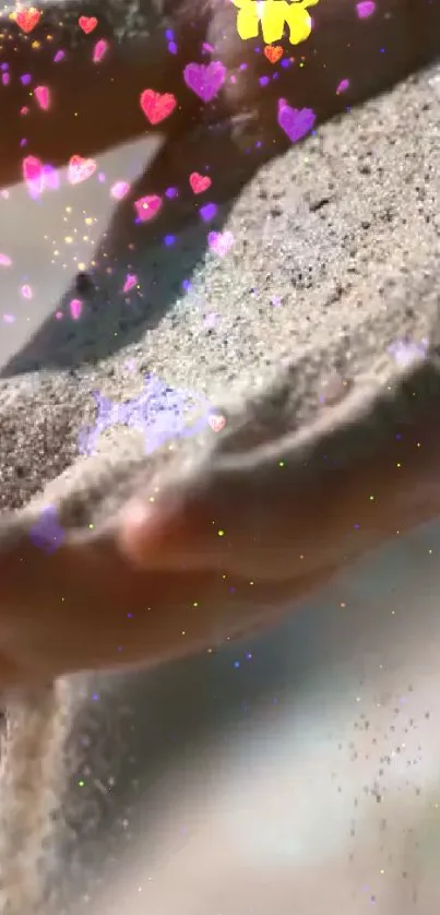 Sand flowing through hands with colorful hearts.