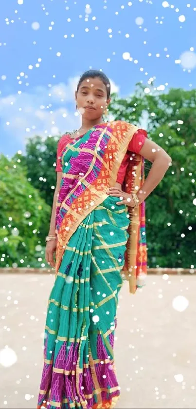 Woman in colorful sari with a snowy effect outdoors.