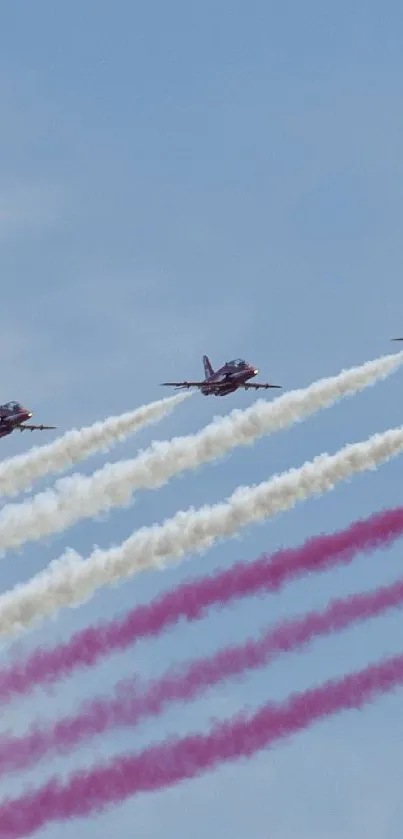 Jets streaming colorful trails across a clear blue sky.