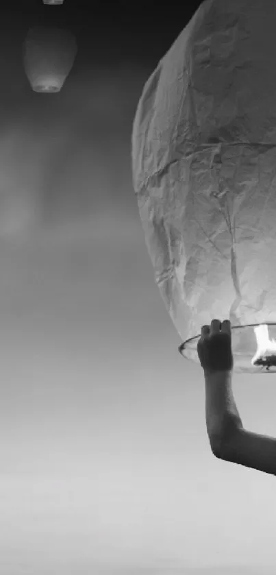 Boy releases a glowing lantern into a vibrant, colorful sunset.