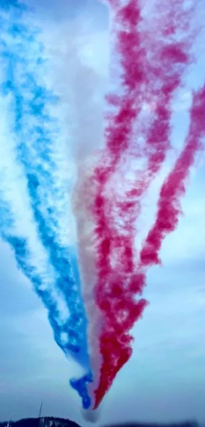 Vibrant blue and red smoke trails in a clear sky wallpaper.