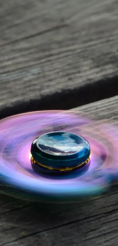 Colorful fidget spinner on rustic wooden planks.