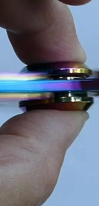 Colorful fidget spinner in motion with metallic rings.