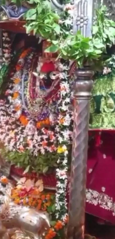 Colorful goddess statue adorned with flowers and garlands.