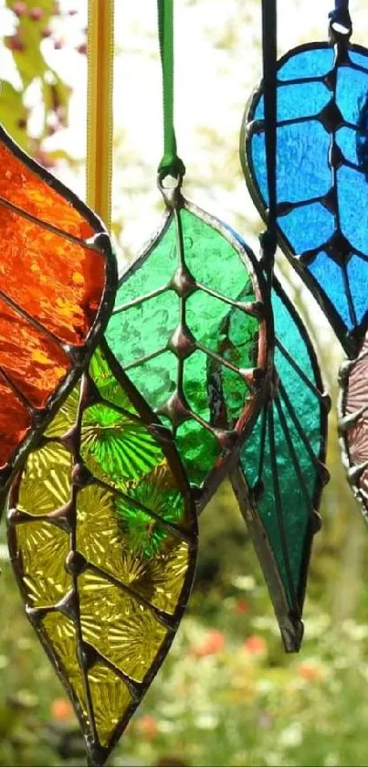 Hanging stained glass leaves in vibrant hues.