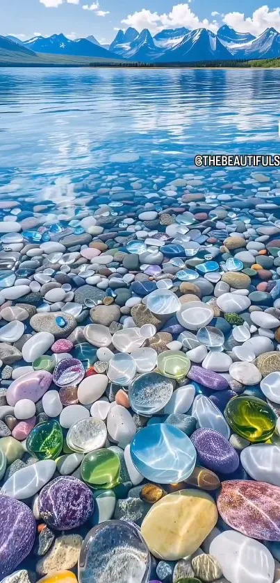 Colorful stones on a serene lakeside with mountains.