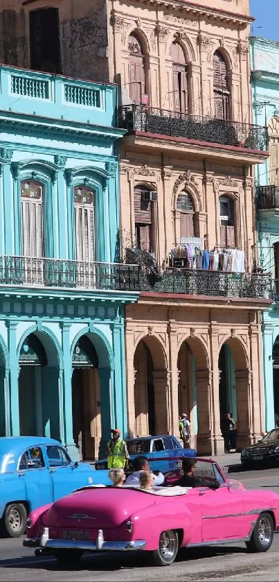 Vibrant Havana street with colorful buildings and vintage cars.